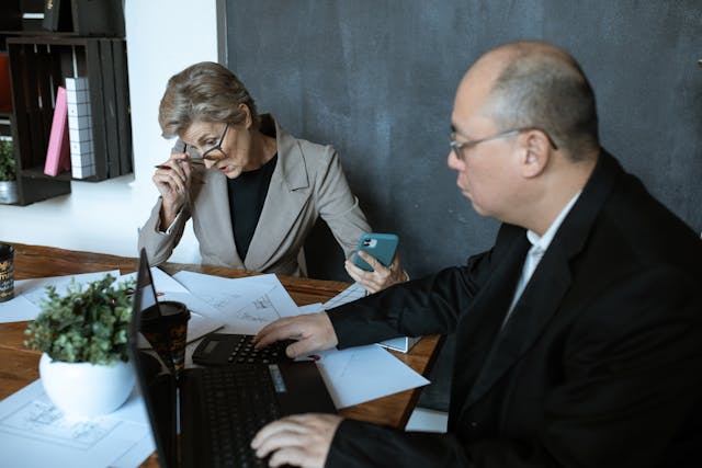 two%20people%20looking%20over%20documents%20with%20calculators two%20people%20looking%20over%20documents%20with%20calculators